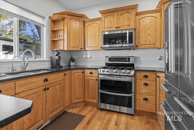 605 W Highland Ave, Nampa, ID 83686 - kitchen with a sink, appliances with stainless steel finishes, tasteful backsplash, and light wood-type flooring