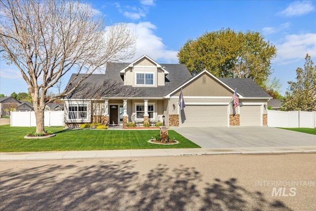 605 W Highland Ave, Nampa, ID 83686 - view of front of home featuring an attached garage, fence, covered porch, and a front yard