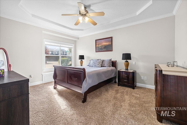 605 W Highland Ave, Nampa, ID 83686 - bedroom featuring ornamental molding, a ceiling fan, a tray ceiling, and light colored carpet