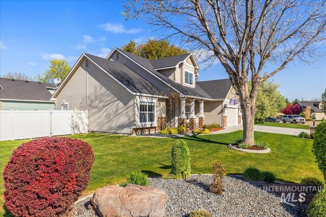 605 W Highland Ave, Nampa, ID 83686 - view of front of house featuring concrete driveway, fence, a front yard, and a garage