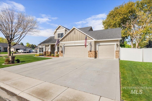 605 W Highland Ave, Nampa, ID 83686 - craftsman-style house with fence, a front yard, board and batten siding, an attached garage, and driveway