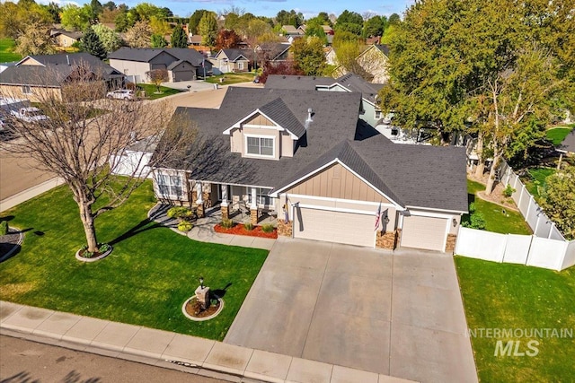 605 W Highland Ave, Nampa, ID 83686 - view of front of home with a garage, fence, a front yard, board and batten siding, and concrete driveway