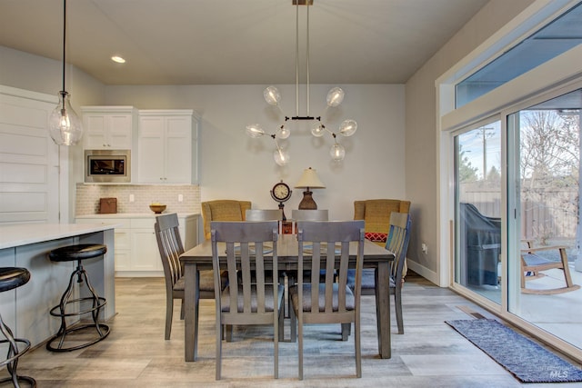 dining space with light wood-type flooring