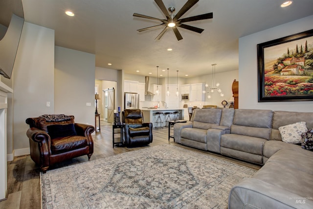 living room with light wood-type flooring and ceiling fan