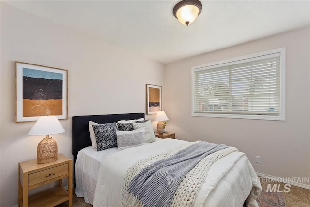 carpeted bedroom with baseboards