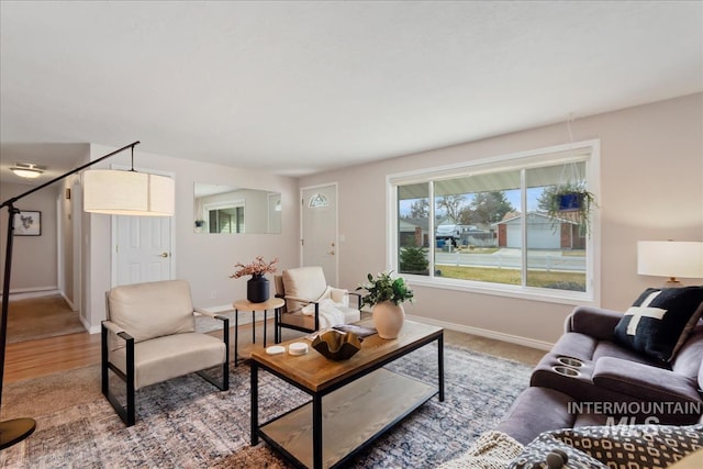 living area with wood finished floors and baseboards