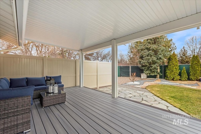 wooden terrace featuring a fenced backyard, a patio, and an outdoor hangout area