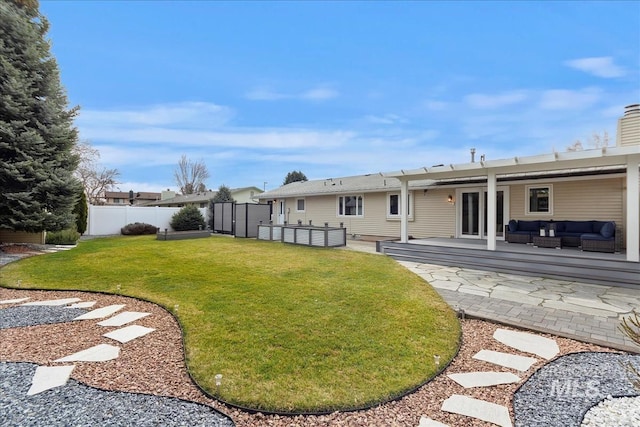 view of yard featuring a patio area, outdoor lounge area, and fence