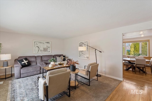 living area with wood finished floors and baseboards