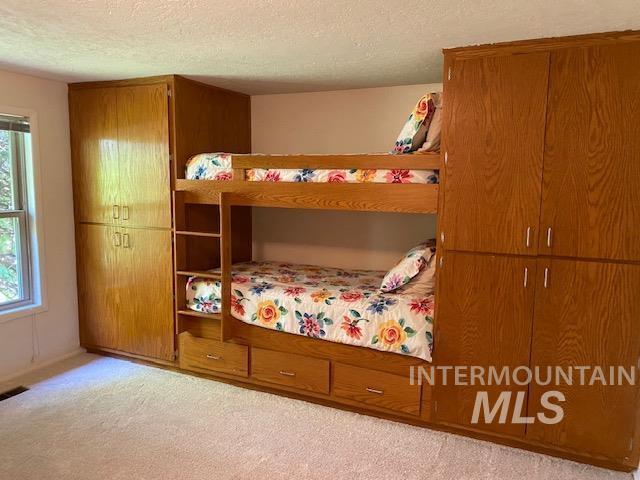 bedroom featuring carpet floors and a textured ceiling