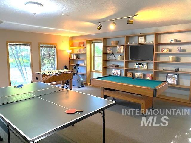 rec room featuring billiards, healthy amount of natural light, and a textured ceiling