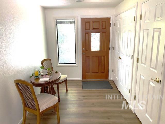 foyer entrance featuring wood finished floors and baseboards