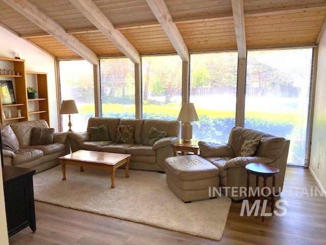 living room featuring wood ceiling and wood finished floors