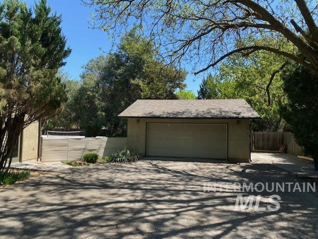 detached garage featuring fence
