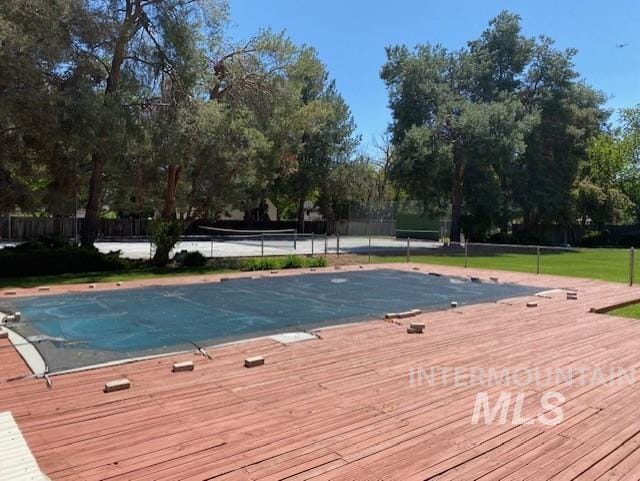 view of pool with fence and a deck