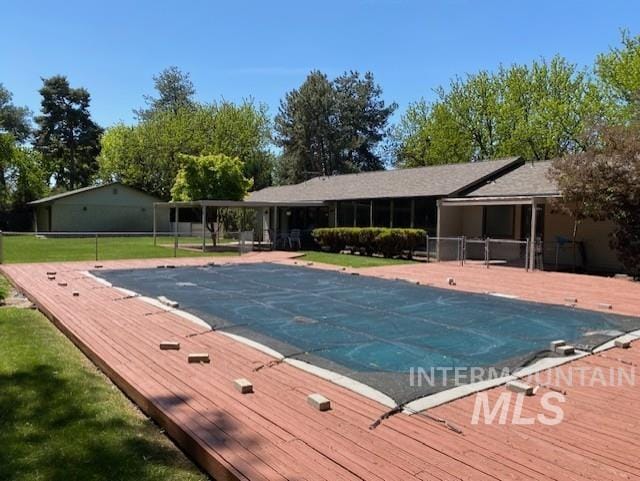 view of swimming pool with a covered pool and a wooden deck
