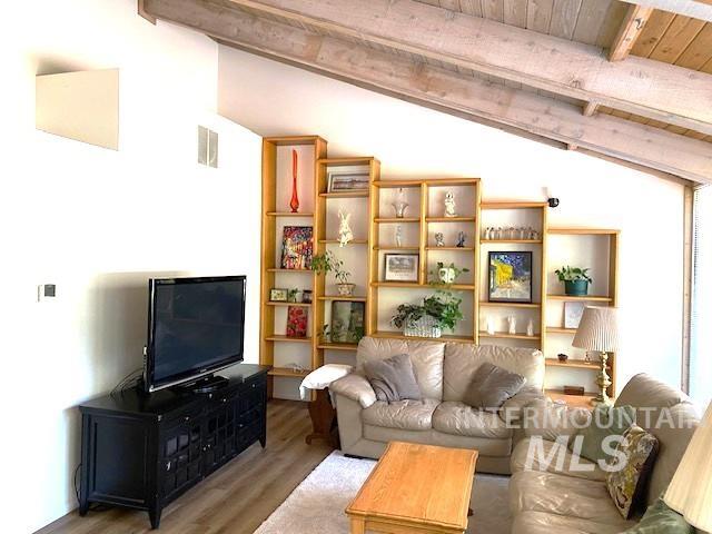 living room featuring wood finished floors and wood ceiling
