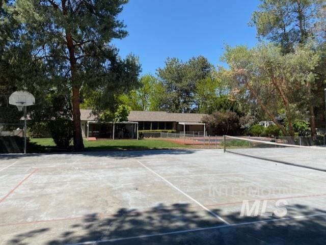 view of tennis court featuring fence