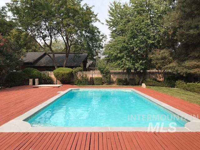 view of swimming pool featuring a fenced backyard and a wooden deck