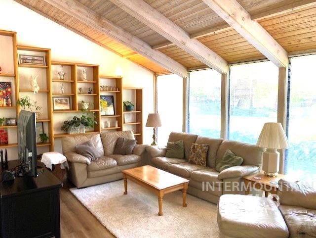 living area featuring wood ceiling and wood finished floors