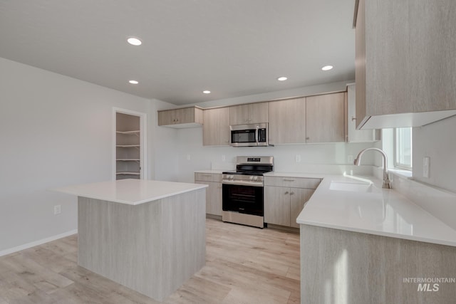 868 Morrow St, Mountain Home, ID 83647 - kitchen featuring appliances with stainless steel finishes, light brown cabinetry, light wood-type flooring, recessed lighting, and light countertops