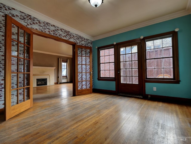 spare room with hardwood / wood-style flooring, ornamental molding, and french doors