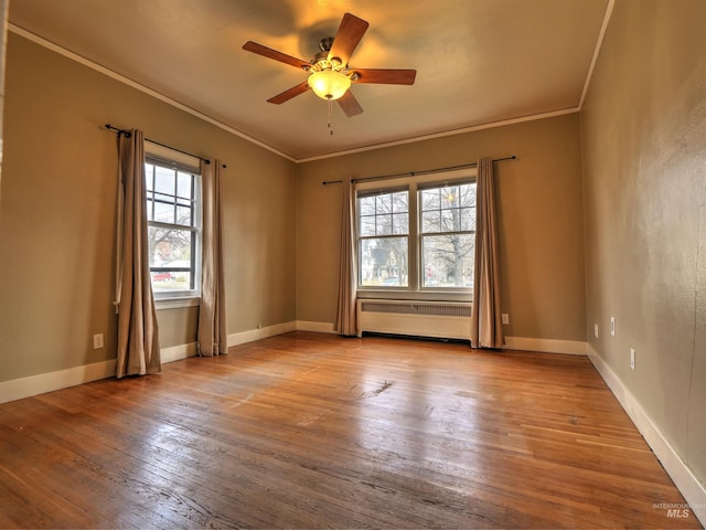 unfurnished room featuring radiator, crown molding, light hardwood / wood-style floors, and ceiling fan