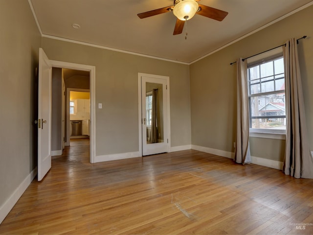 empty room with crown molding, ceiling fan, and light hardwood / wood-style flooring