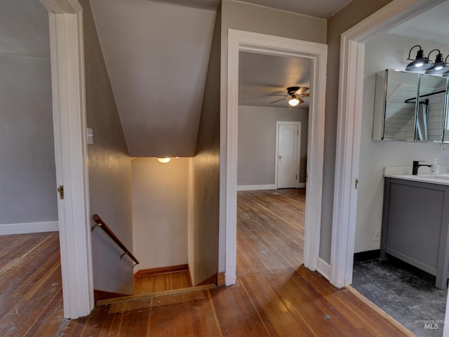 stairs with ceiling fan and hardwood / wood-style floors