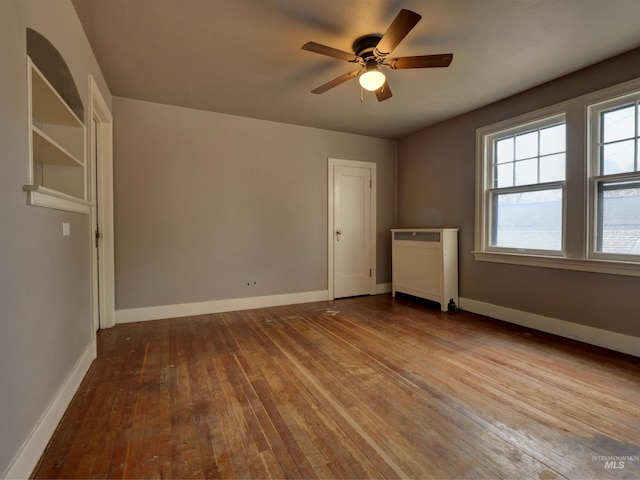 unfurnished bedroom with radiator, light hardwood / wood-style floors, and ceiling fan