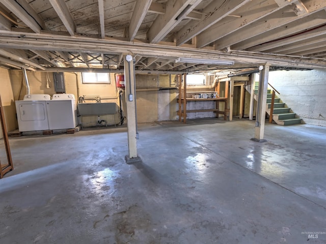 basement with sink, plenty of natural light, and washer and dryer