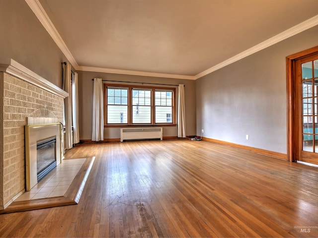 unfurnished living room featuring a brick fireplace, light hardwood / wood-style flooring, and ornamental molding