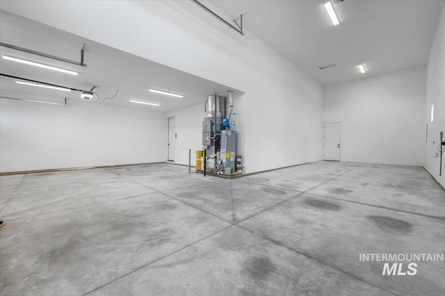 garage with water heater and a garage door opener