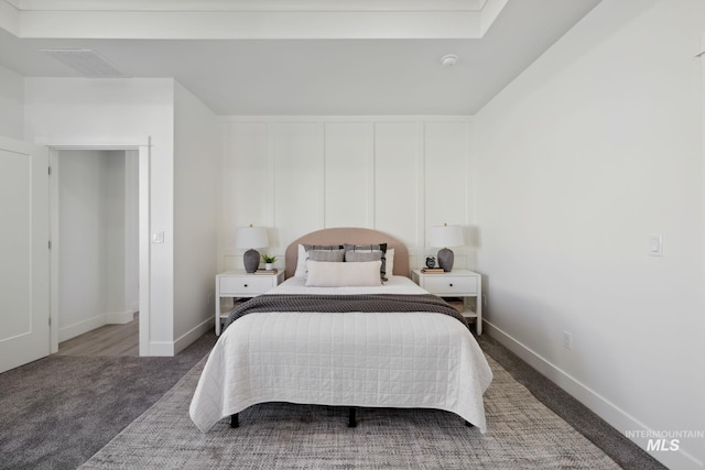 carpeted bedroom featuring visible vents and baseboards
