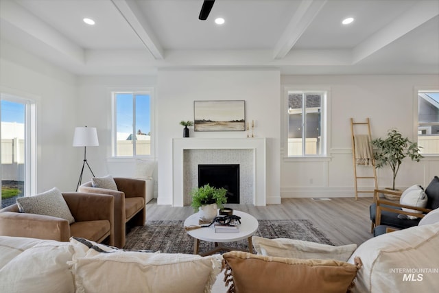 living room with recessed lighting, beamed ceiling, wood finished floors, ceiling fan, and a fireplace