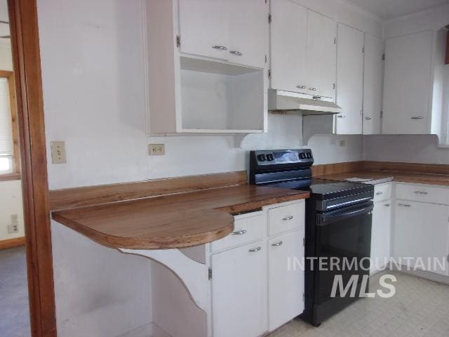 kitchen featuring dark countertops, white cabinets, black range with electric cooktop, and under cabinet range hood