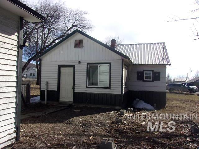 rear view of property featuring metal roof