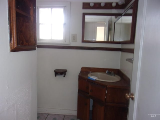 bathroom featuring baseboards and vanity