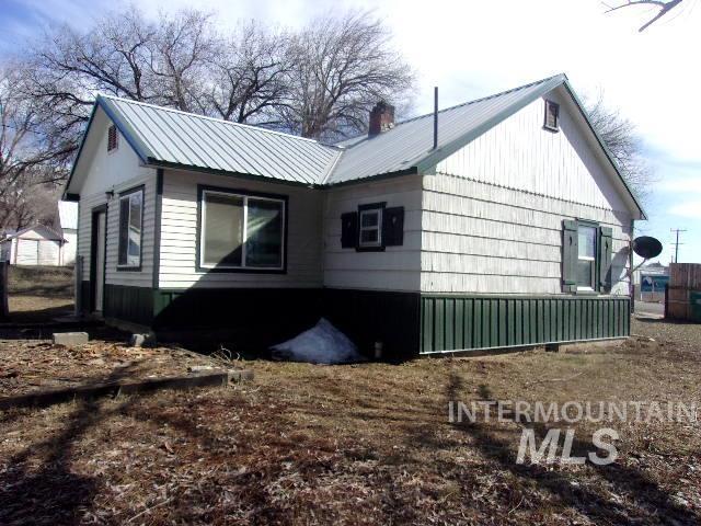 view of home's exterior featuring metal roof and a chimney