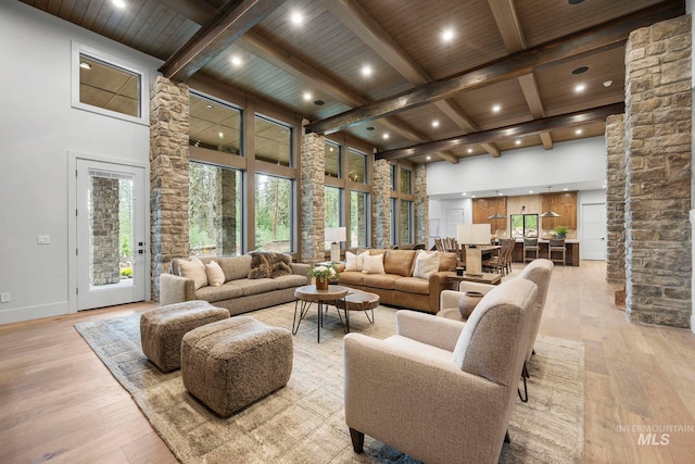 1010 Elo Rd, Mccall, ID 83638 - living area with a high ceiling, light wood-style floors, a wooden ceiling with exposed beams, recessed lighting, and decorative columns