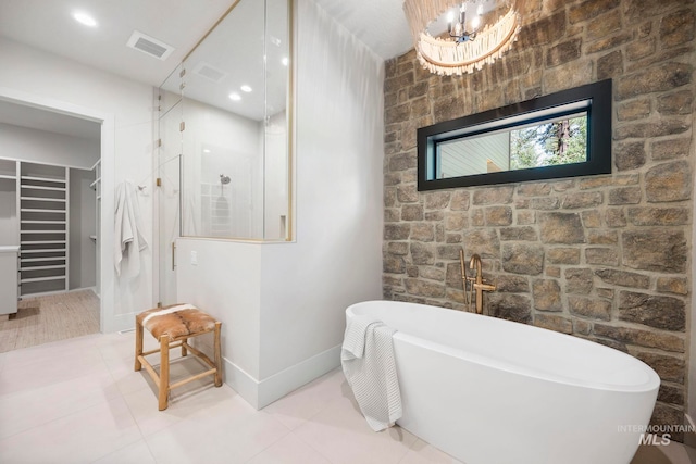 1010 Elo Rd, Mccall, ID 83638 - bathroom featuring a soaking tub, a spacious closet, a walk in shower, and tile patterned flooring