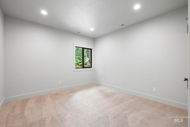 1010 Elo Rd, Mccall, ID 83638 - empty room featuring light carpet, recessed lighting, and a textured ceiling