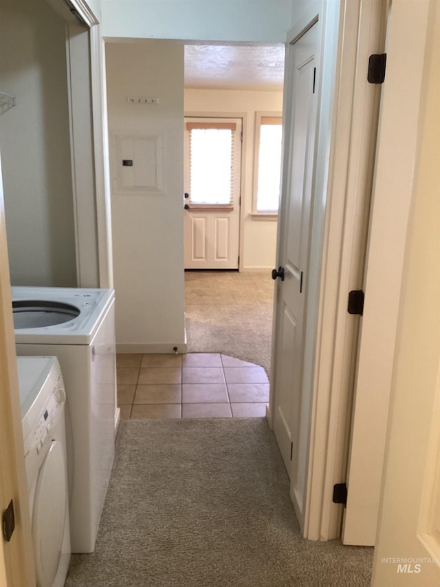 laundry area with washing machine and dryer and light carpet