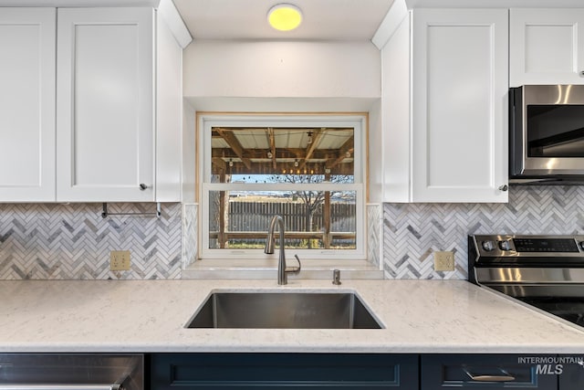 kitchen with white cabinets, stainless steel appliances, and sink