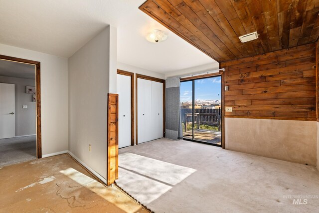 entryway featuring wood ceiling and wooden walls