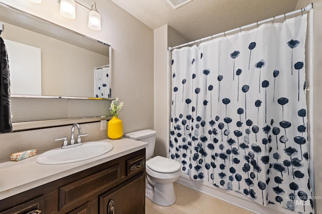 bathroom with vanity, a shower with curtain, a textured ceiling, and toilet