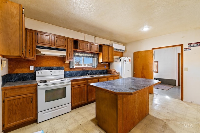 kitchen with sink, a wall mounted AC, a textured ceiling, white appliances, and a kitchen island