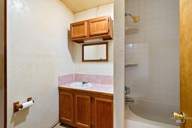 bathroom featuring vanity and tiled shower / bath