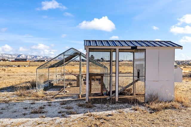 view of outbuilding with a mountain view and a rural view