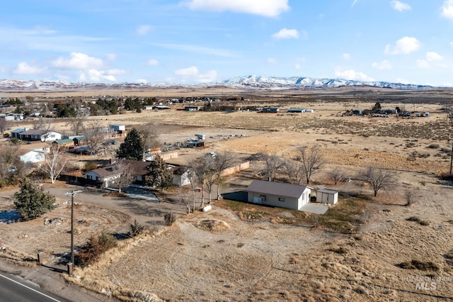 drone / aerial view featuring a mountain view and a rural view